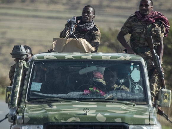 FILE - In this Saturday, May 8, 2021 file photo, Ethiopian government soldiers ride in the back of a truck on a road near Agula, north of Mekele, in the Tigray region of northern Ethiopia. Ethiopia&#0 ...