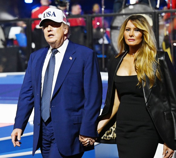 epa13038119 US President Donald Trump and First Lady Melania Trump return to the residence after the UFC Freedom 250 event on the South Lawn of the White House in Washington, DC, USA, 14 June 2026. Th ...