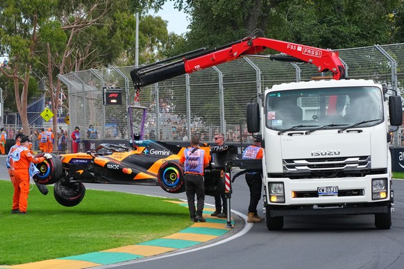 McLaren driver Oscar Piastri of Australia's car is taken from the track track after he crashed during the formation lap ahead of the Australian Formula One Grand Prix at Albert Park, in Melbourne ...