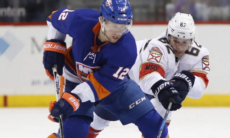 Florida Panthers center Denis Malgin (62) of Switzerland defends New York Islanders right wing Josh Bailey (12) during the first period of an NHL hockey game in New York, Monday, March 26, 2018. (AP P ...