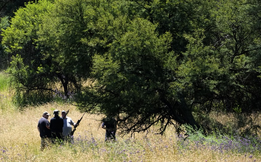 Local community police group looking for a tiger, which escaped from its enclosure, in Walkerville, south of Johannesburg, South Africa, Monday, January 16, 2023. Authorities in South Africa are looking for…