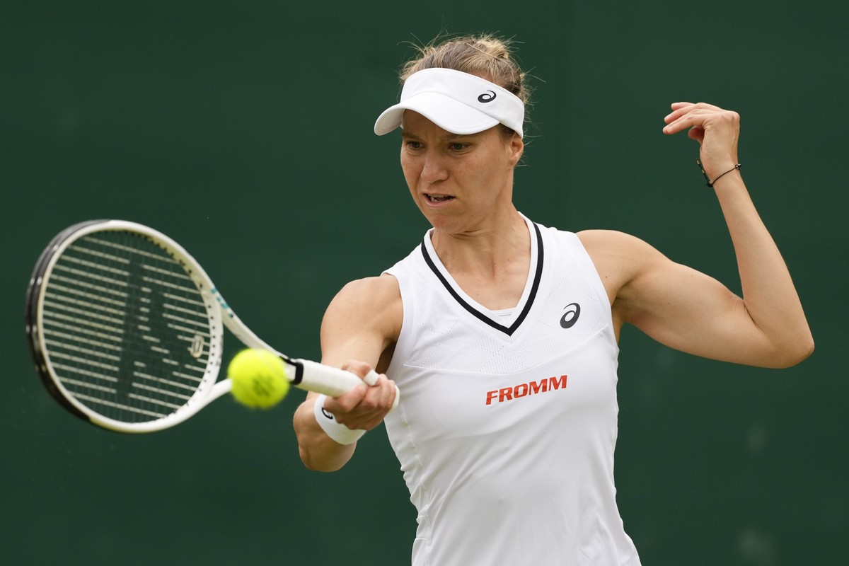 Viktorija Golubic of Switzerland plays a forehand return to Jule Niemeier of Germany during their match on day three at the Wimbledon tennis championships in London, Wednesday, July 3, 2024. (AP Photo ...