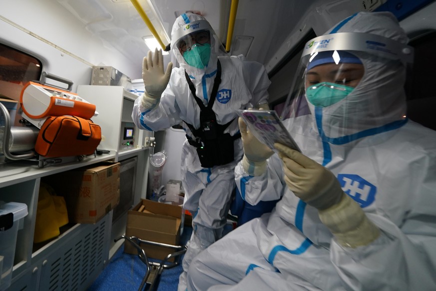 A medical worker waves while transporting Associated Press photographer Matt Slocum after a positive coronavirus test at the 2022 Winter Olympics, Wednesday, Feb. 9, 2022, in Beijing. Slocum was monit ...