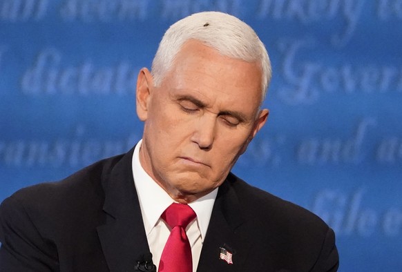 Vice President Mike Pence listens to Democratic vice presidential candidate Sen. Kamala Harris, D-Calif., during the vice presidential debate Wednesday, Oct. 7, 2020, at Kingsbury Hall on the campus o ...