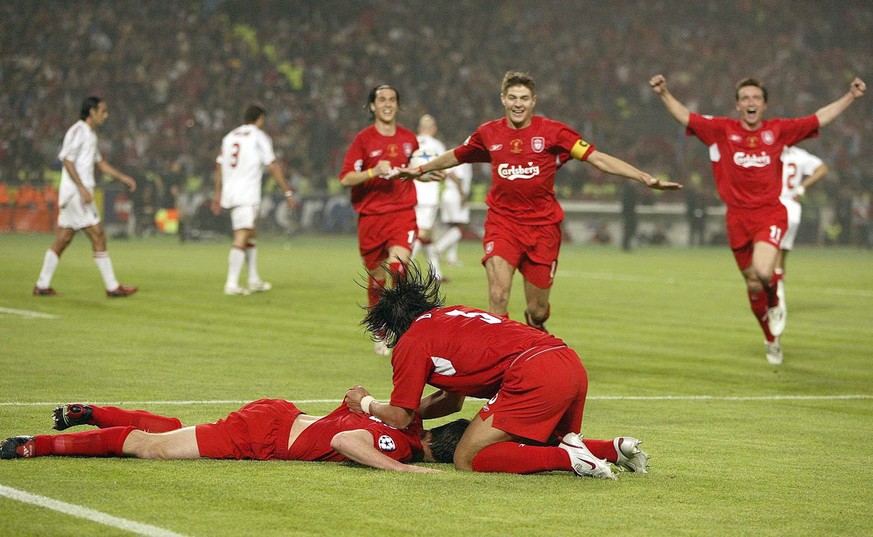 Liverpool&#039;s Xabi Alonso, left on the ground, is congratulated by teammates after scoring from a penalty rebound against AC Milan during the Champions League Final at The Ataturk Olympic Stadium,  ...
