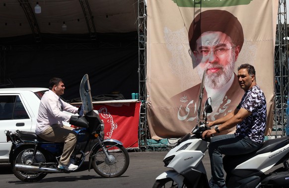 epa13038365 Iranians drive past a billboard of Iranian supreme leader Ayatollah Mojtaba Khamenei at Valiasr Square in Tehran, Iran, 15 June 2026. US President Donald Trump announced on his social medi ...