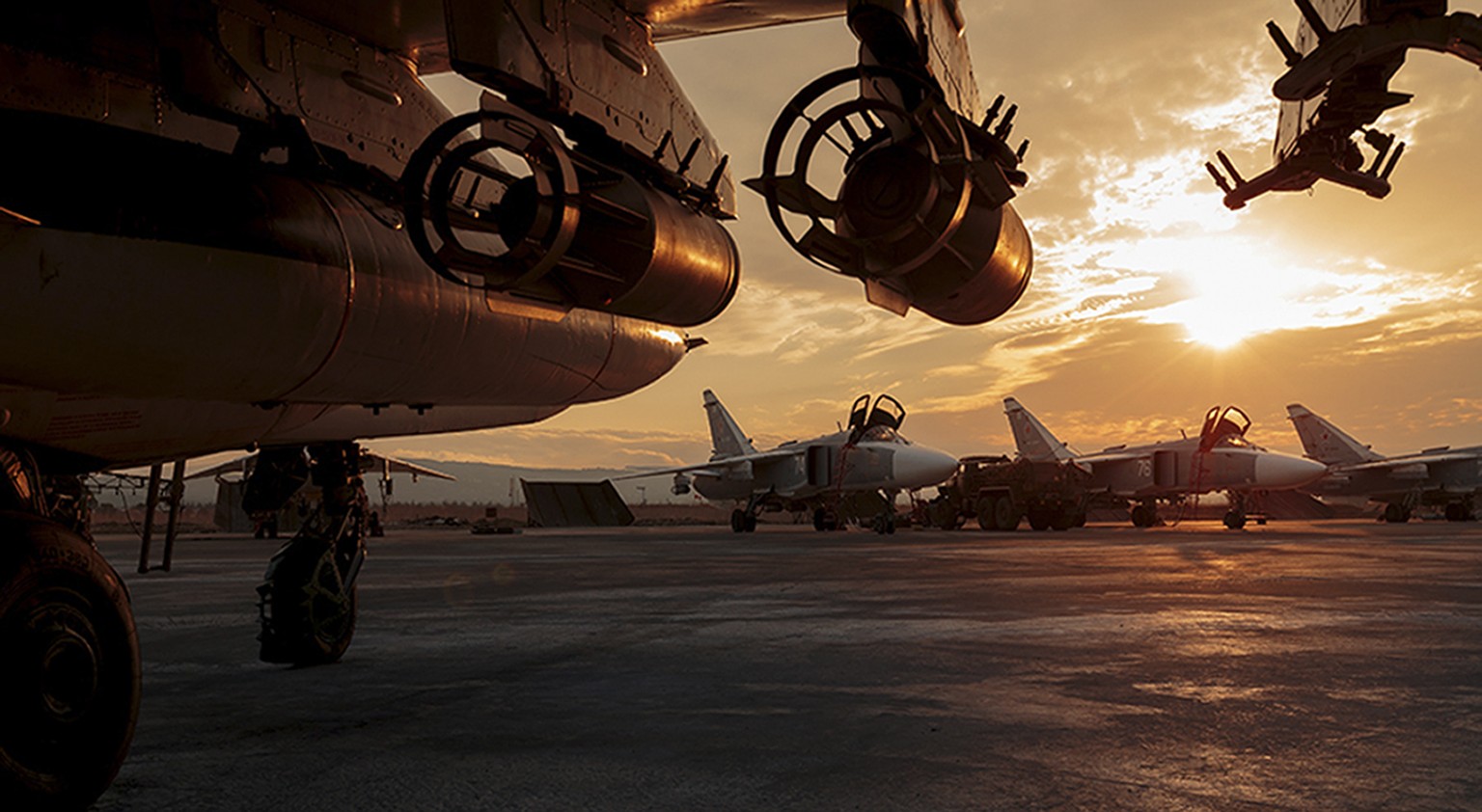 This photo taken on Friday, Dec. 18, 2015 and provided by the Russian Defense Press Service, shows a Russian Su-25 ground attack jet parked at the Hemeimeem air base in Syria, with Su-24 bombers seen  ...