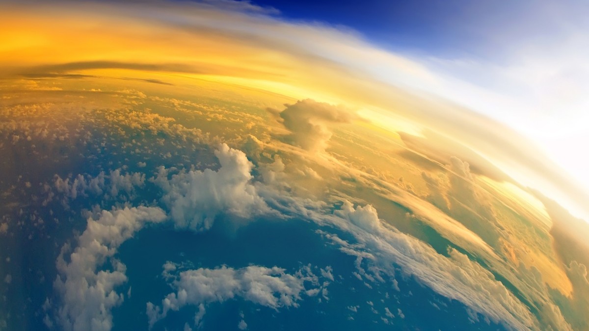 "Aerial view of Planet Earth with clouds, horizon and little bit of space, make feelings of being in heaven. Dramatic clouds and orange sunlight all over the planet. Cloudscape and stratosphere f ...