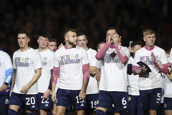 Scotland players celebrate as they stand on the pitch at the end of the Euro 2024 group A soccer match between Scotland and Norway at Hampden Park in Glasgow, Scotland, Sunday, Nov. 19, 2023. The matc ...