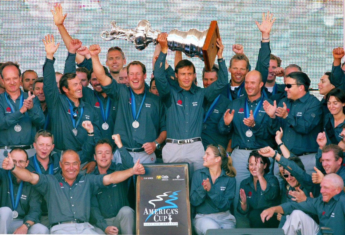 Ernesto Bertarelli, center, displays the America's Cup as he is surrounded by his jubilant Alinghi team members during the official prizegiving and closing ceremony of the America's Cup in A ...