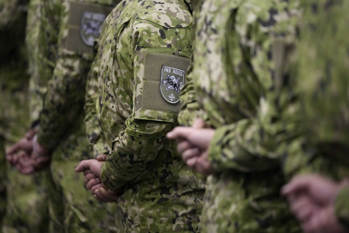 Soldiers wearing the patch of their NATO mission stand during a farewell ceremony for departing troops, in a hangar at the military airport in Lisbon, Friday, April 15, 2022. On Friday, 222 Portuguese ...