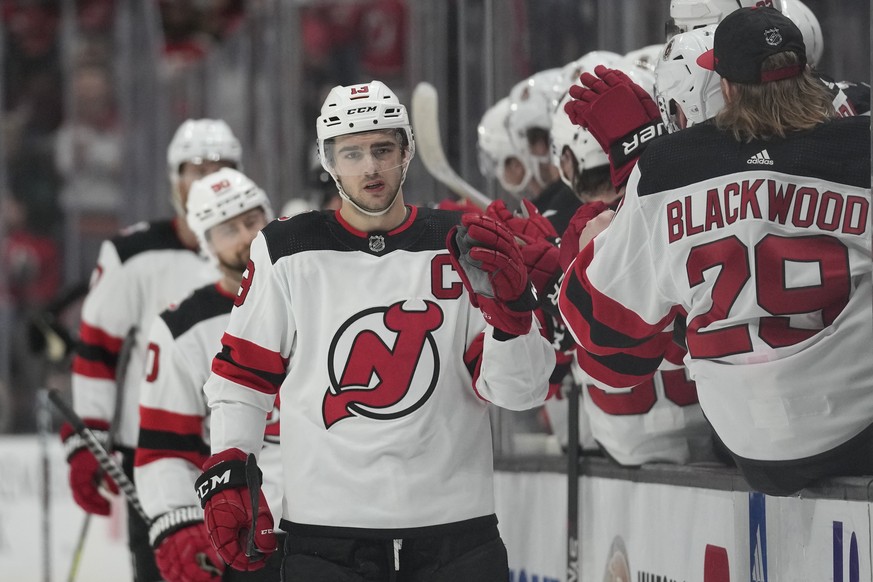 New Jersey Devils center Nico Hischier (13) is greeted by teammates after scoring during the first period of an NHL hockey game against the Anaheim Ducks in Anaheim, Calif., Friday, Jan. 13, 2023. (AP ...