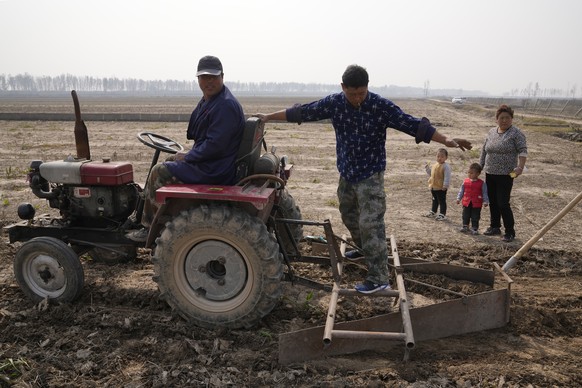 Farmers prepare to till a farmland that was submerged by recent floods in Huangtugang village in central China&#039;s Henan province on Saturday, Oct. 23, 2021. The flooding disaster in July is the wo ...