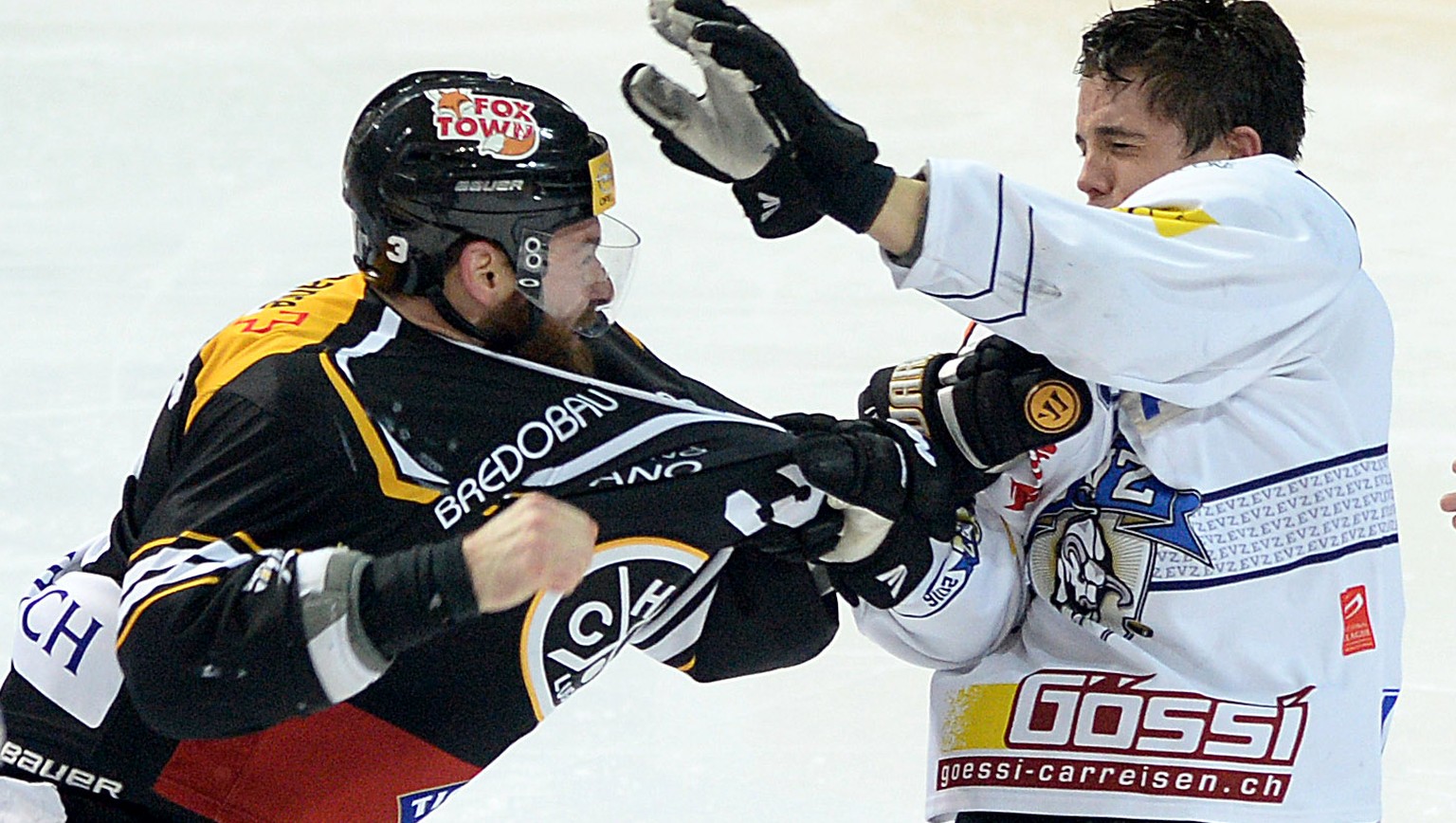 Luganos Julien Vauclair, links, und Zugs Reto, rechts, kaempfen um den Puck, im Eishockey Meisterschaftsspiel der National League A zwischen dem HC Lugano und dem EV Zug, in der Resega-Halle in Lugano ...