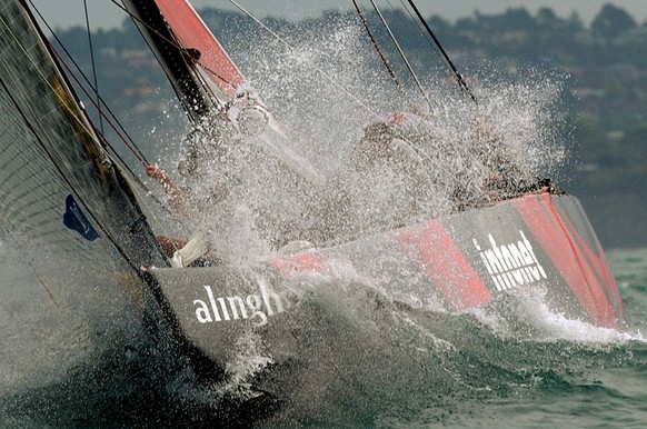 Swiss Defi yacht Alinghi, SUI-64, sailing in a wave during the fifth match-race against the New Zealander defender yacht, Team New Zealand, NZL-82, during the America&#039;s Cup final, in Hauraki gulf ...