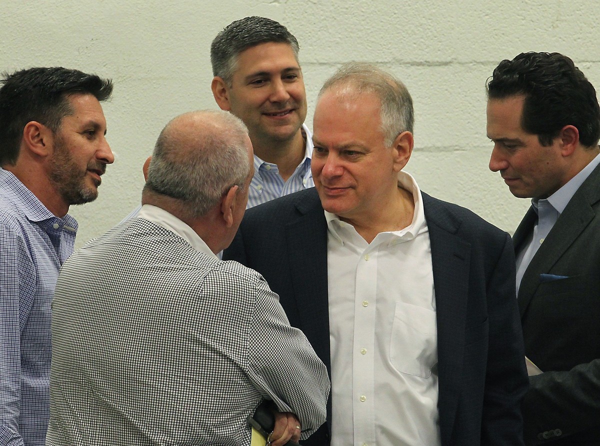 In this Dec. 20, 2016 photo, Stephen Bittel, center, chats with voters as members of the Miami-Dade Democratic Party Executive Committee meet in Wynwood, Fla., to elect a new state committeeman. Flori ...