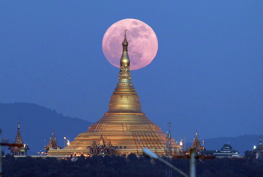 The moon rises behind the Uppatasanti Pagoda seen in Naypyitaw, Myanmar, Sunday, Dec. 3, 2017. The Dec. 3 full moon is the first of three consecutive supermoons. The two will occur on Jan. 1 and Jan.  ...