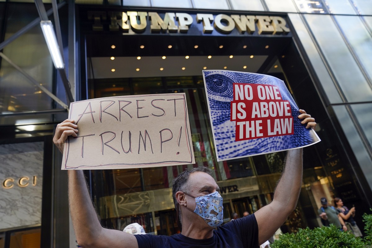 A protester stands in front of Trump Tower in New York, Tuesday, Aug. 9, 2022. The FBI's search of Donald Trump's Mar-a-Lago estate marked a dramatic and unprecedented escalation of the law  ...