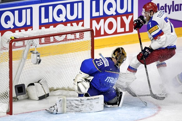 epa05948238 Russia&#039;s forward Ivan Telegin (R) in action against Italy&#039;s goalie Frederic Cloutier (L) during the 2017 IIHF Ice Hockey World Championship group A preliminary round match betwee ...