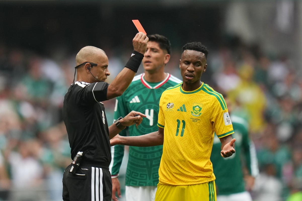 Referee Wilton Sampaio, of Brazil, show the red card to South Africa's Themba Zwane during the World Cup Group A soccer match between Mexico and South Africa in Mexico City, Thursday, June 11, 20 ...