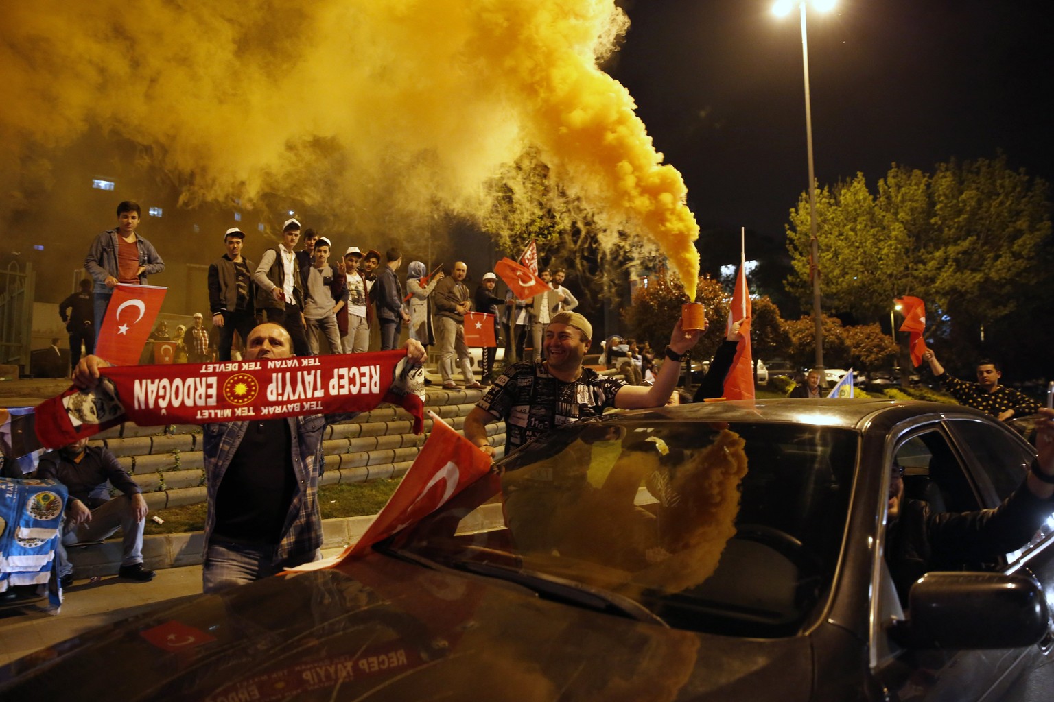 epa05911584 Supporters of Turkish President Erdogan celebrate as preliminary results of the constitutional referendum are announced in Istanbul, Turkey, 16 April 2017. State-run news agency Anadolu re ...