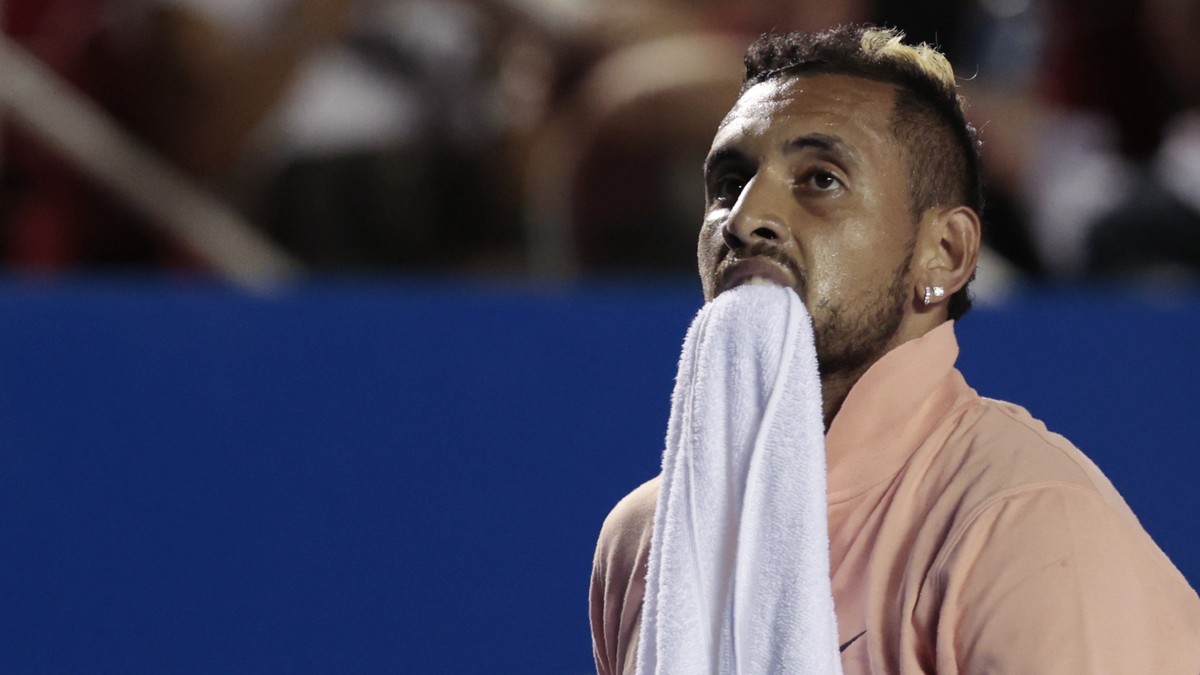 Australia's Nick Kyrgios carries a towel between his teeth during an opening-round match against France's Ugo Humbert at the Mexican Open tennis tournament in Acapulco, Mexico, Tuesday, Feb. ...