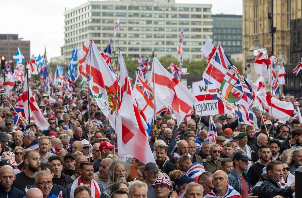 epa12373404 Protesters wave flags as they march during a 'Unite the Kingdom' rally in central London, Britain, 13 September 2025. Two opposing demonstrations, involving tens of thousands of  ...