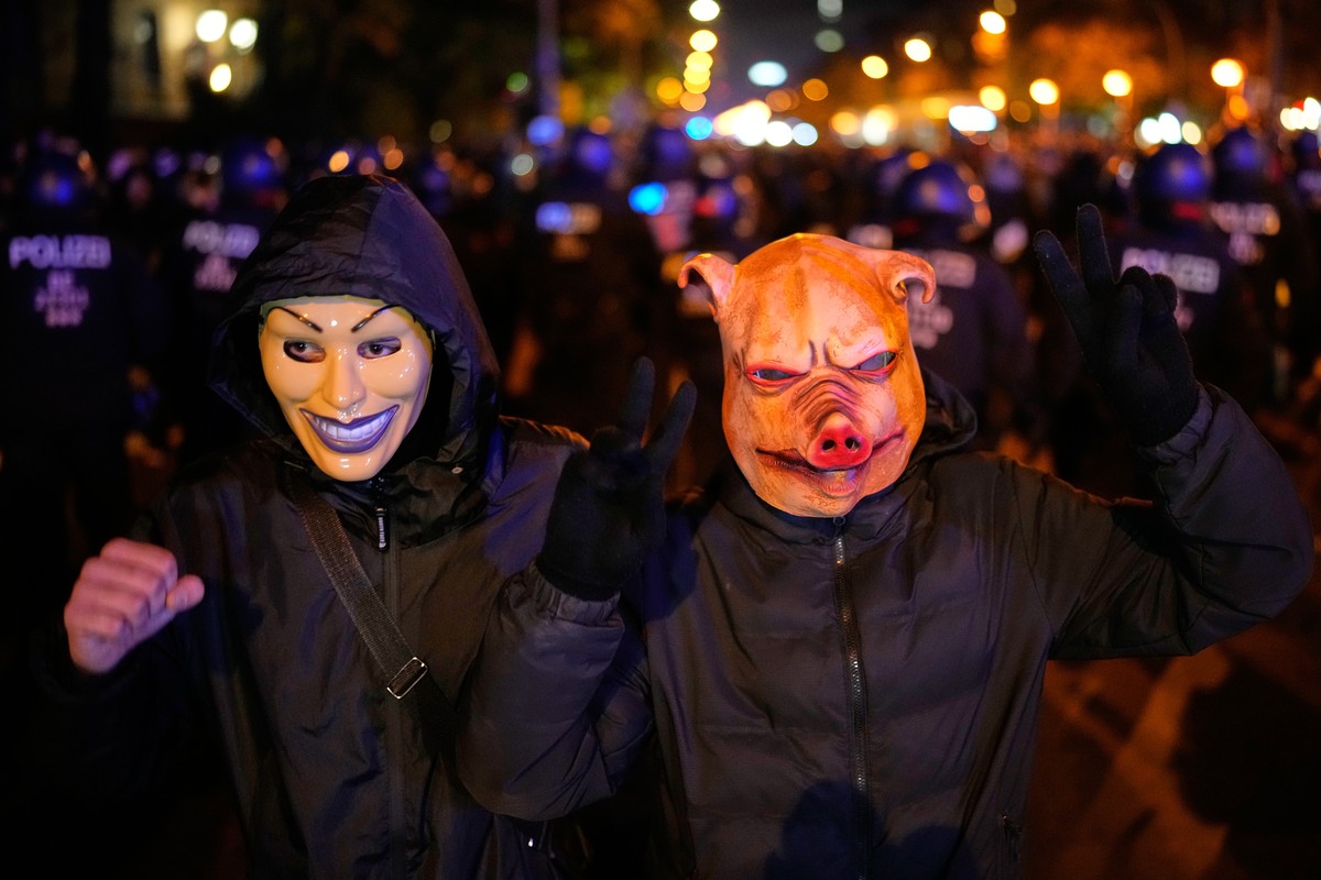 Demonstrators pose with Halloween masks as they attend a protest under the slogan "Gen Z Takes Care of It" in Frankfurt, Germany, Saturday, Oct. 31, 2026. (AP Photo/Ebrahim Noroozi) CORRECTI ...
