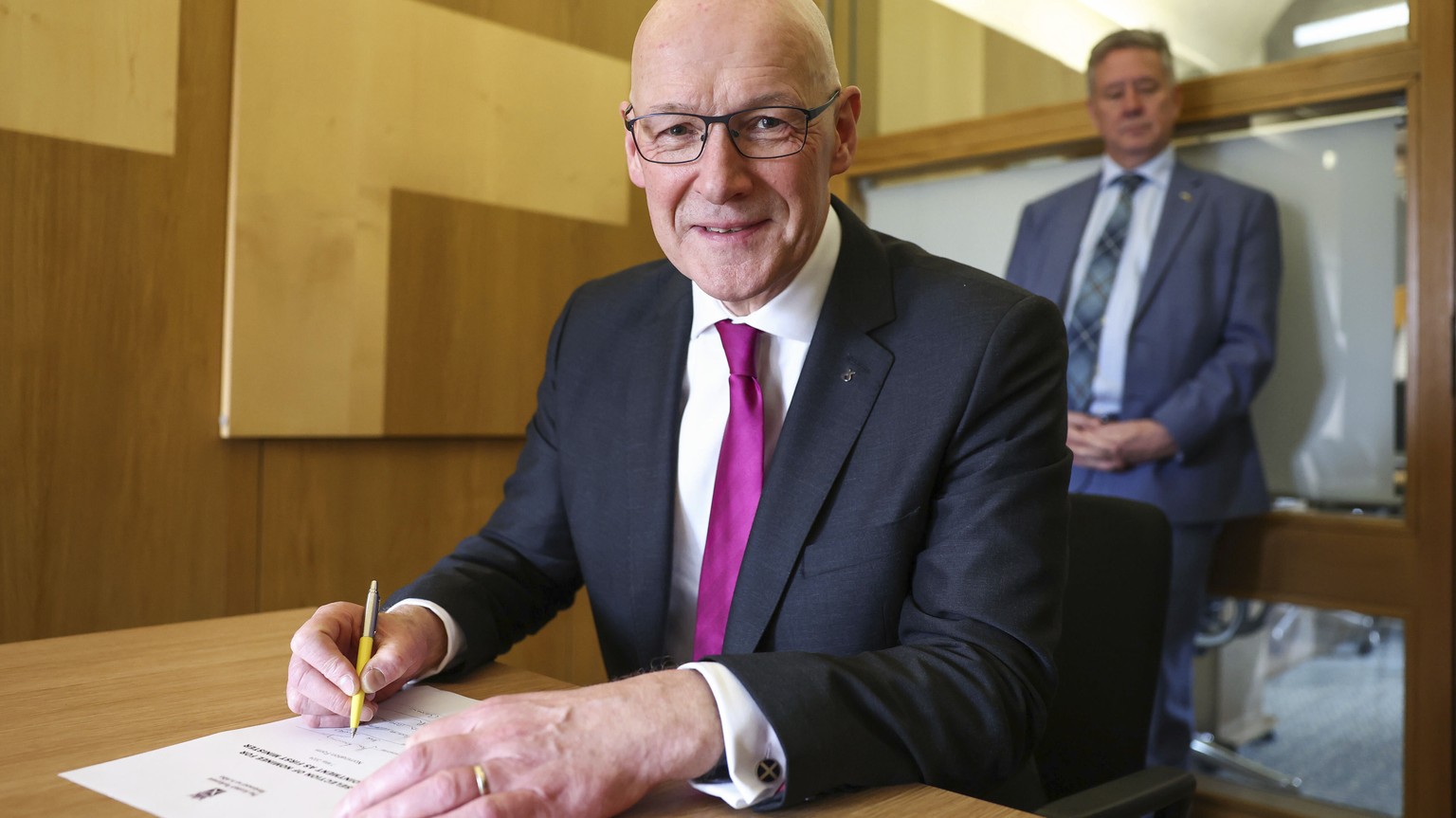New Scottish National Party (SNP) leader John Swinney signs his letter of nomination to become First Minister at the Scottish Parliament in Edinburgh, Tuesday, May 7, 2024. (Jeff J Mitchell/PA via AP)