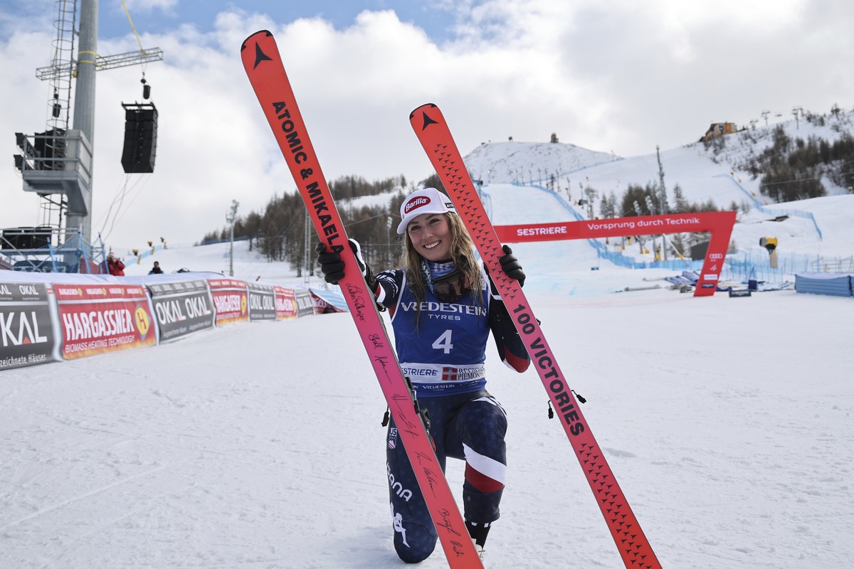 United States' Mikaela Shiffrin poses with her commemorative skis for her 100th victory after an alpine ski, women's World Cup slalom, in Sestriere, Italy, Sunday, Feb. 23, 2025. (AP Photo/M ...