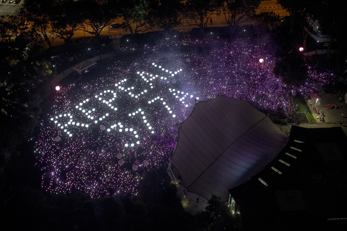 epa10131771 (FILE) - A general view shows the words 'Repeal 377A' referencing a law that criminalises sexual acts between men formed by the crowd during the Pink Dot event held at the Speake ...
