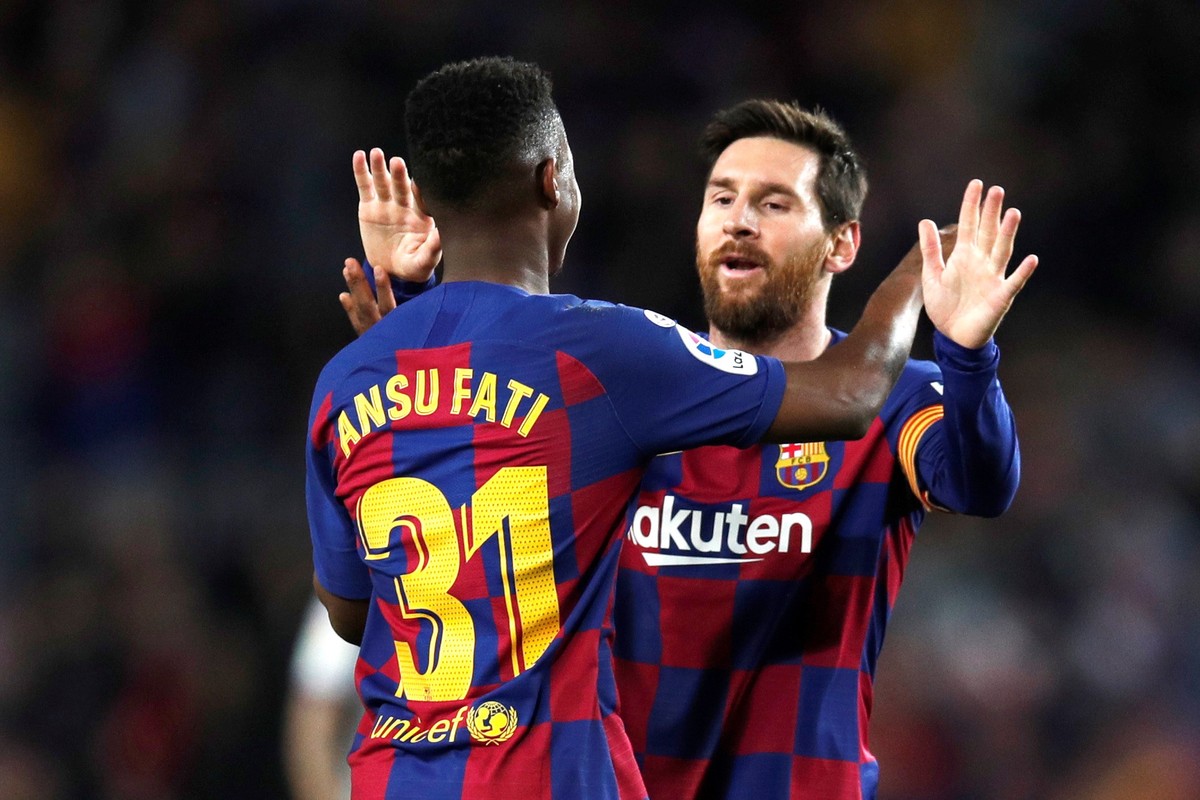 epa08188937 FC Barcelona's Ansu Fati (front) celebrates with teammate Lionel Messi after scoring during the Spanish LaLiga soccer match between FC Barcelona and UD Levante played at the Camp Nou  ...