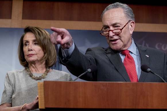 Senate Minority Leader Sen. Chuck Schumer of N.Y., accompanied by Speaker Nancy Pelosi of Calif., left, calls on a reporter during a news conference on Capitol Hill in Washington, Friday, Jan. 25, 201 ...