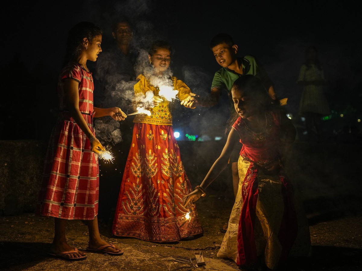 Children light the fire crackers during Diwali, the festival of lights in Mumbai, India, Monday, Oct. 24, 2022. Indians across the country are celebrating Diwali, the Hindu festival that symbolizes th ...
