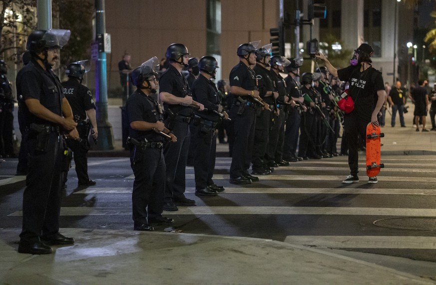 epa08692687 Protesters confront Los Angeles police during a demonstration held to demand justice for the death of Breonna Taylor after the results of a grand jury indictment of former Louisville polic ...