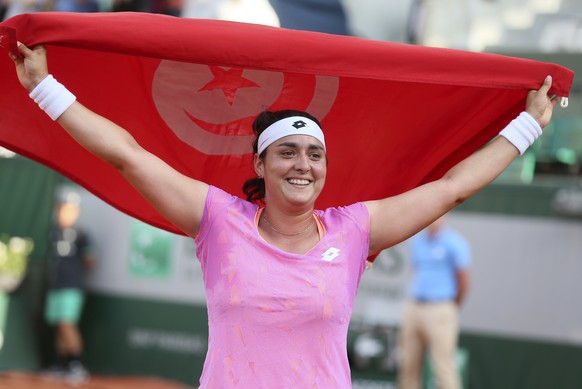 Tunisia&#039;s Ons Jabeur displays her national flag after defeating Slovakia&#039;s Dominika Cibulkova during their second round match of the French Open tennis tournament at the Roland Garros stadiu ...
