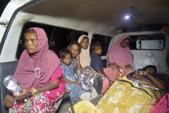 Ethnic Rohingya women and children sit inside an ambulance upon arrival at a temporary shelter after their boat landed in Pidie, Aceh province, Indonesia, Monday, Dec. 26, 2022. A second group in two  ...