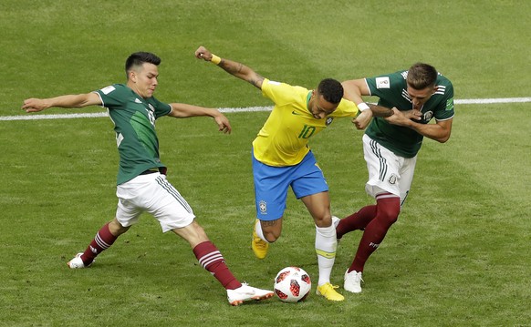 Brazil&#039;s Neymar, center, challenges for the ball with Mexico&#039;s Hirving Lozano, left, and Mexico&#039;s Hector Herrera during the round of 16 match between Brazil and Mexico at the 2018 socce ...