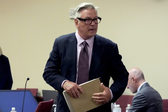 epa11470899 US actor Alec Baldwin stands during a break in his hearing in Santa Fe County District Court, in Santa Fe, New Mexico, USA, 10 July 2024. Baldwin is facing a single charge of involuntary m ...
