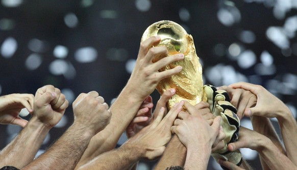 epa05708933 (FILE) A file picture dated 09 July 2006 shows the FIFA World Cup trophy in the hands of the cheering Italian players after the FIFA World Cup 2006 final Italy vs France in Berlin, Germany ...