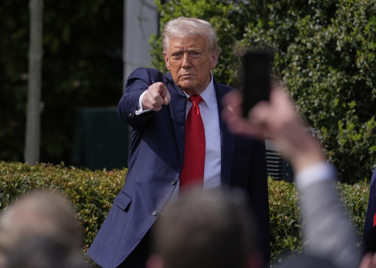 President Donald Trump gestures to the crowd as he departs after welcoming the 2025 College Football National Champions, the Ohio State University football team, during an event on the South Lawn of t ...