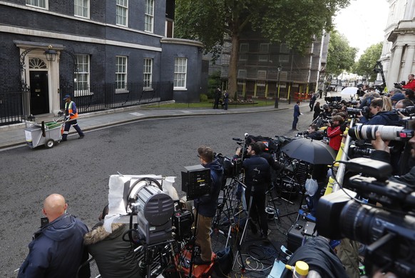 A road sweep takes his trolley on the road outside 10 Downing street in London, Friday, June 9, 2017. British Prime Minister Theresa May&#039;s gamble in calling an early election backfired spectacula ...