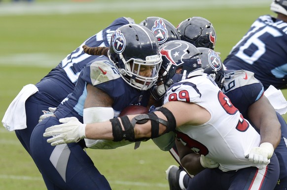 Houston Texans defensive end J.J. Watt (99) stops Tennessee Titans running back Derrick Henry (22) in the first half of an NFL football game Sunday, Oct. 18, 2020, in Nashville, Tenn. (AP Photo/Mark Z ...