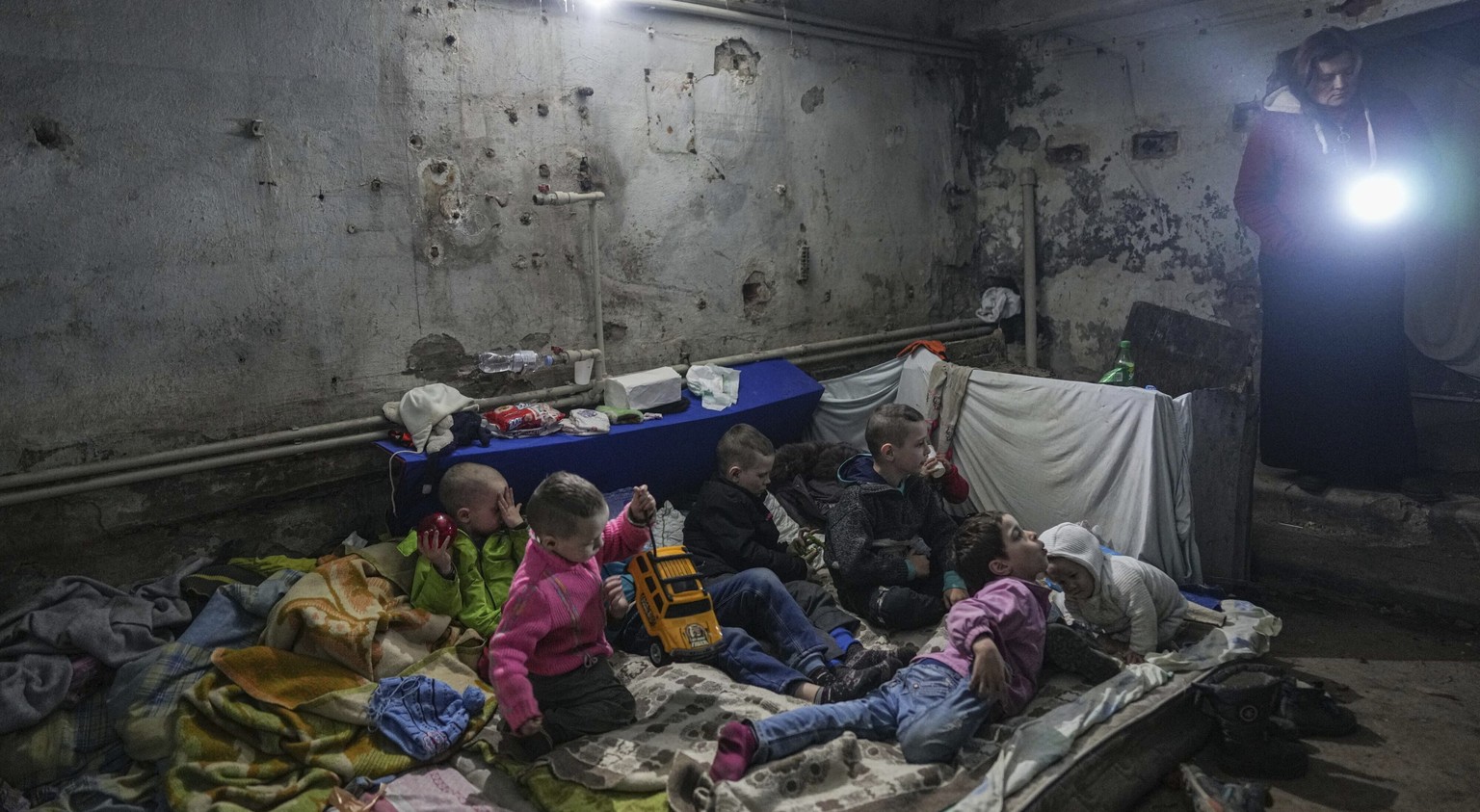 Children play in the bomb shelter in Mariupol, Ukraine, Monday, March 7, 2022. (AP Photo/Evgeniy Maloletka)