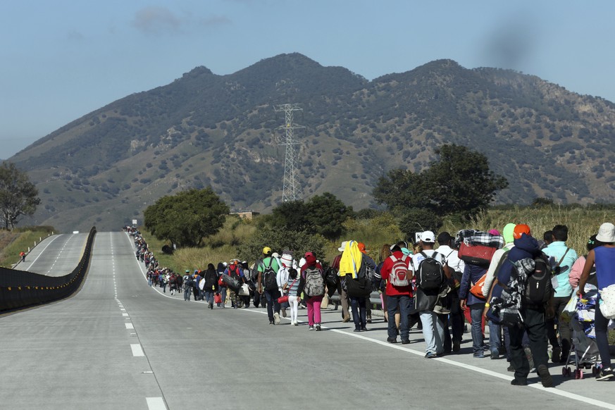 Central American migrants travel as a caravan toward the U.S. border on the highway that connects Guadalajara with Tepic, Mexico, Tuesday, Nov. 13, 2018. Many migrants say they are fleeing rampant pov ...