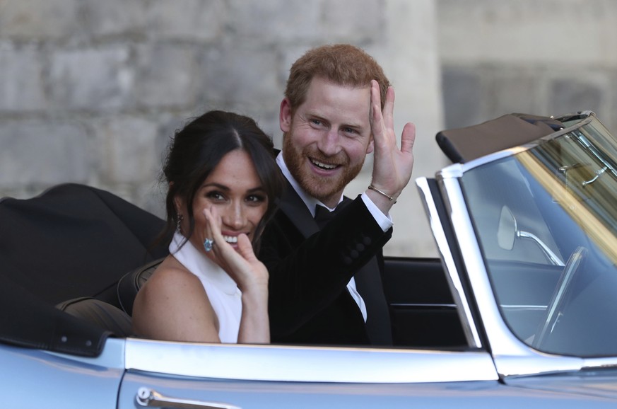 FILE - In this Saturday, May 19, 2018 file photo the newly married Duke and Duchess of Sussex, Meghan Markle and Prince Harry, leave Windsor Castle in a convertible car after their wedding in Windsor, ...