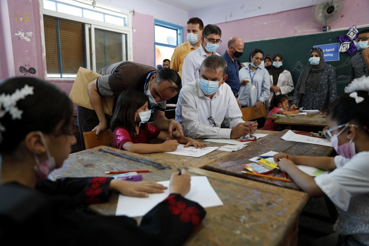 Philippe Lazzarini, center, Commissioner-General of United Nations Relief and Works Agency for Palestine Refugees in the Near East (UNRWA), sits with students participating in an UNRWA summer camp at  ...