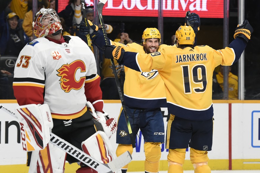 Nashville Predators defenseman Roman Josi (59), of Switzerland, celebrates with center Calle Jarnkrok (19), of Sweden, after Jarnkrok scored against Calgary Flames goaltender David Rittich (33), of th ...