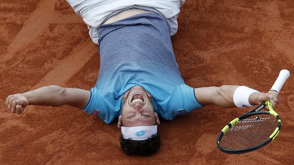 Italy&#039;s Marco Cecchinato lays on the clay as he defats Serbia&#039;s Novak Djokovic during their quarterfinal match of the French Open tennis tournament at the Roland Garros stadium, Tuesday, Jun ...