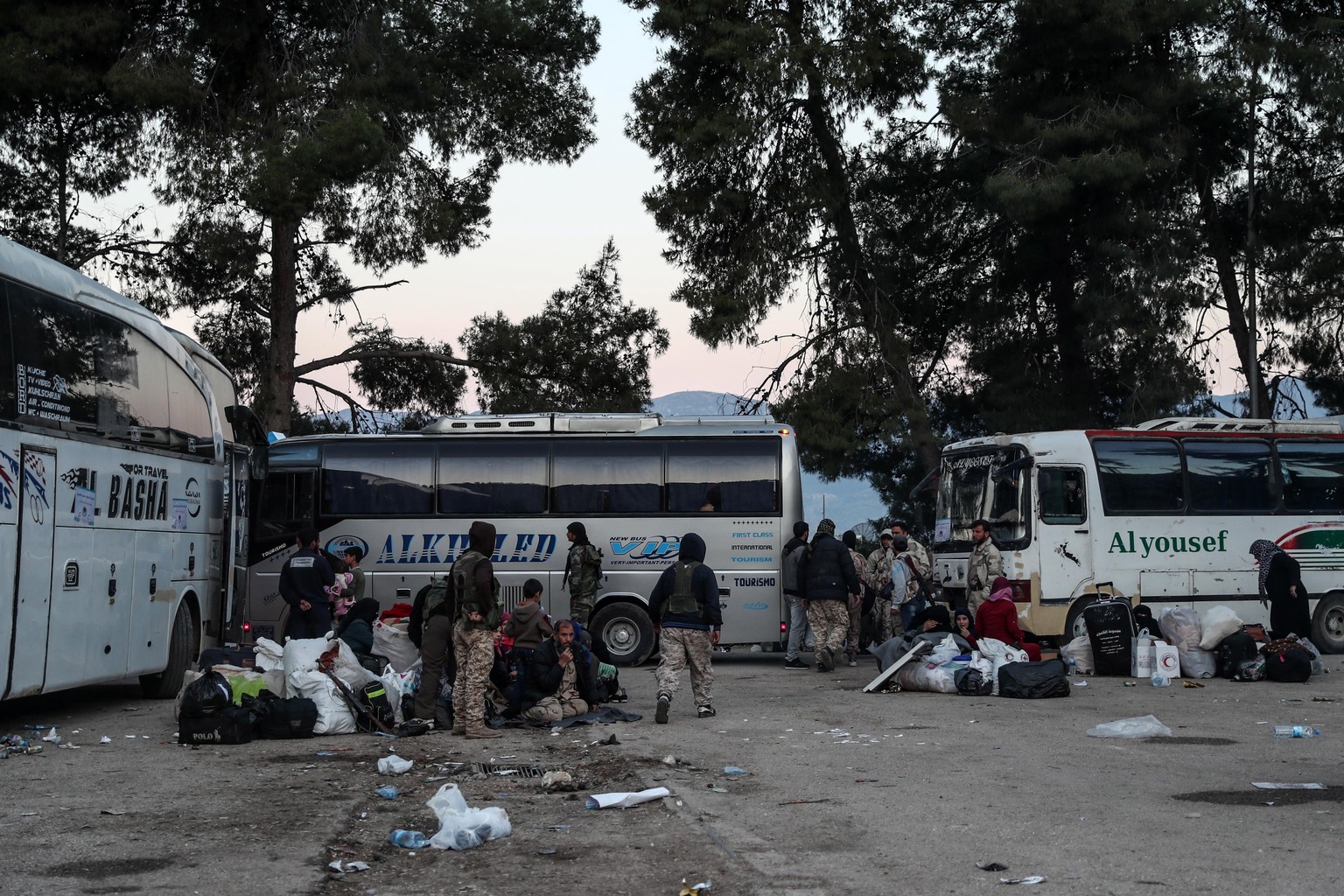 epa06996662 (FILE) - Syrian fighters and their families from the Eastern al-Qalamoun area wait near buses as part of the evacuation process, at Qalaat al-Madiq town, Hama province, Syria, 23 April 201 ...